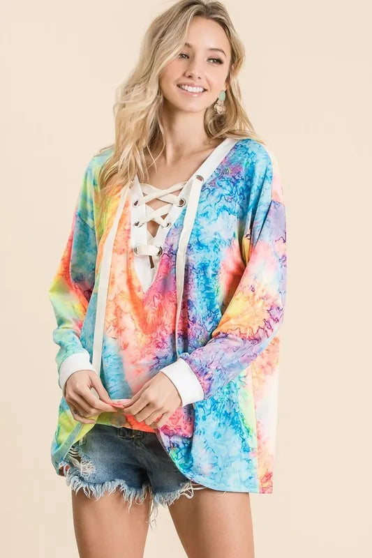 Colorful BiBi tie-dye deep V-neck top with lace-up front, featuring trendy boho design and relaxed fit.
