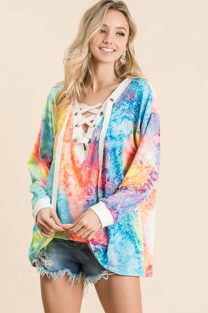 Colorful BiBi tie-dye deep V-neck top with lace-up front, featuring trendy boho design and relaxed fit.