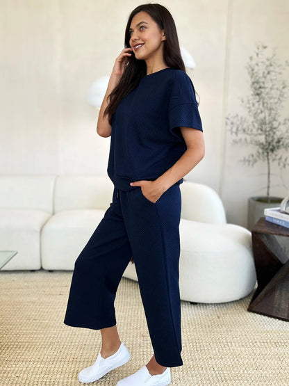 Trendsi Double Take full size texture short sleeve top and matching pants set, shown in a stylish, textured fabric.