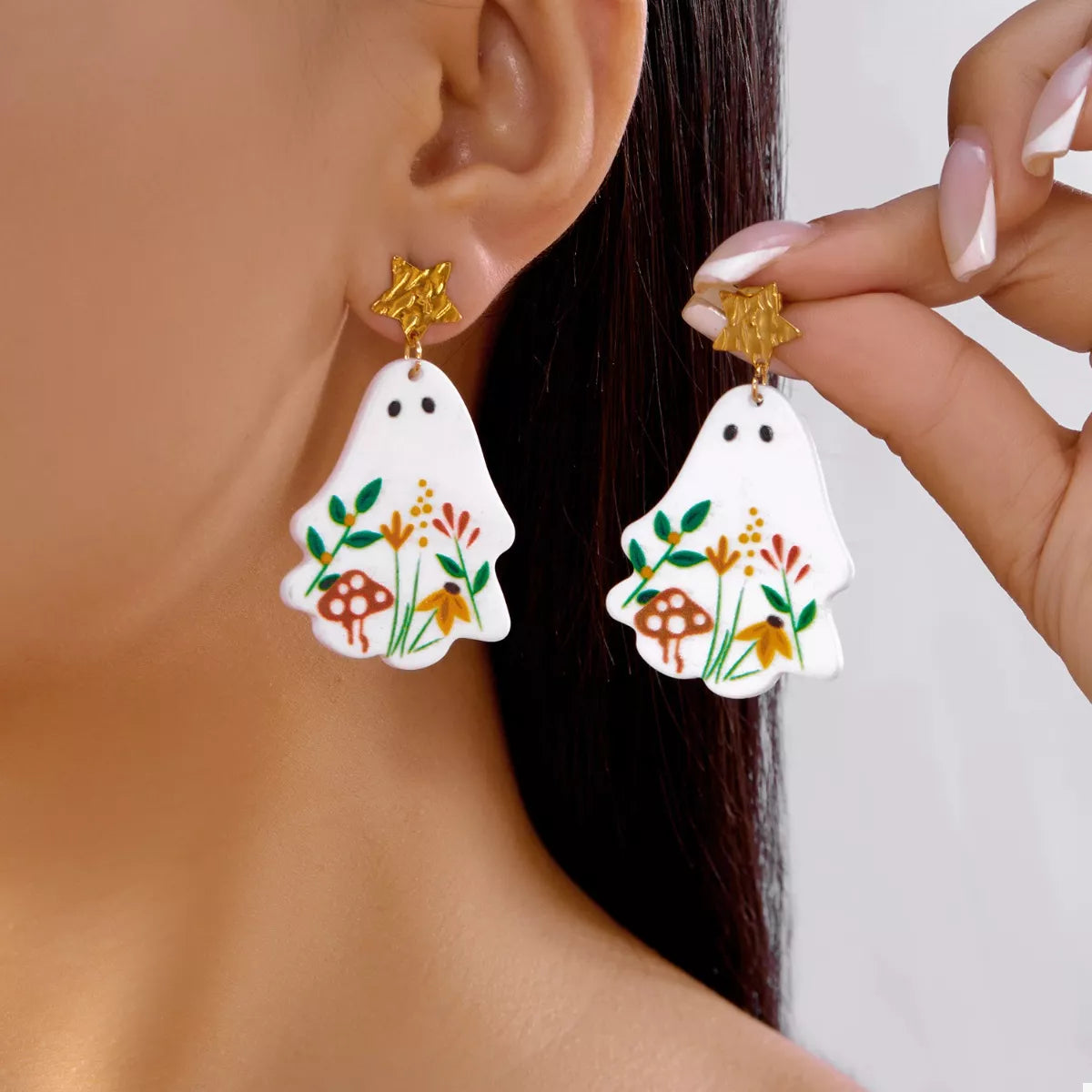 Whimsical ghost earrings with floral design, featuring playful ghost shapes and colorful floral accents for a fun, stylish accessory.