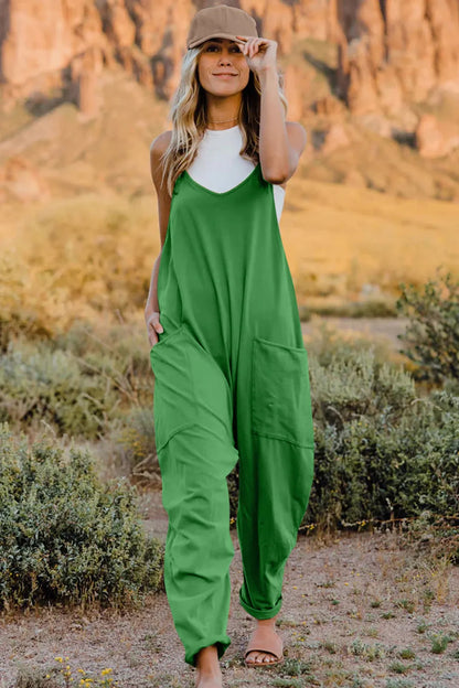 Trendsi double take full size v-neck sleeveless jumpsuit with pockets, shown on a model in a casual indoor setting.