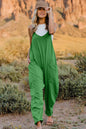 Trendsi double take full size v-neck sleeveless jumpsuit with pockets, shown on a model in a casual indoor setting.