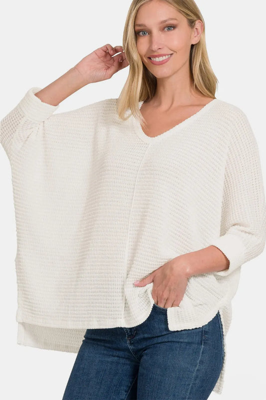 Zenana high-low slit knit top with round neckline, full size, in a stylish design, perfect for casual or chic outfits.