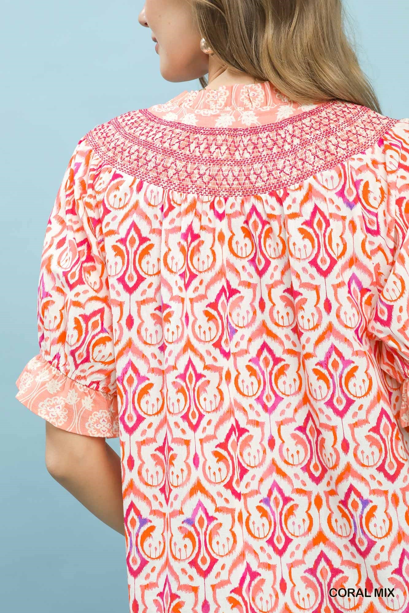 Coral mixed boho puff sleeve smocked top by Umgee featuring a relaxed fit and ruffled neckline, perfect for casual wear.