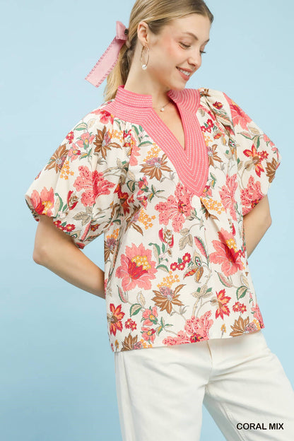 Coral floral puff sleeve blouse by Umgee featuring a mixed floral pattern and lightweight fabric, perfect for casual or dressy occasions.