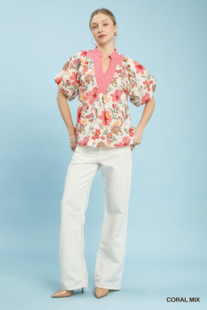 Coral floral puff sleeve blouse by Umgee with a mixed floral pattern, lightweight fabric, and feminine design.