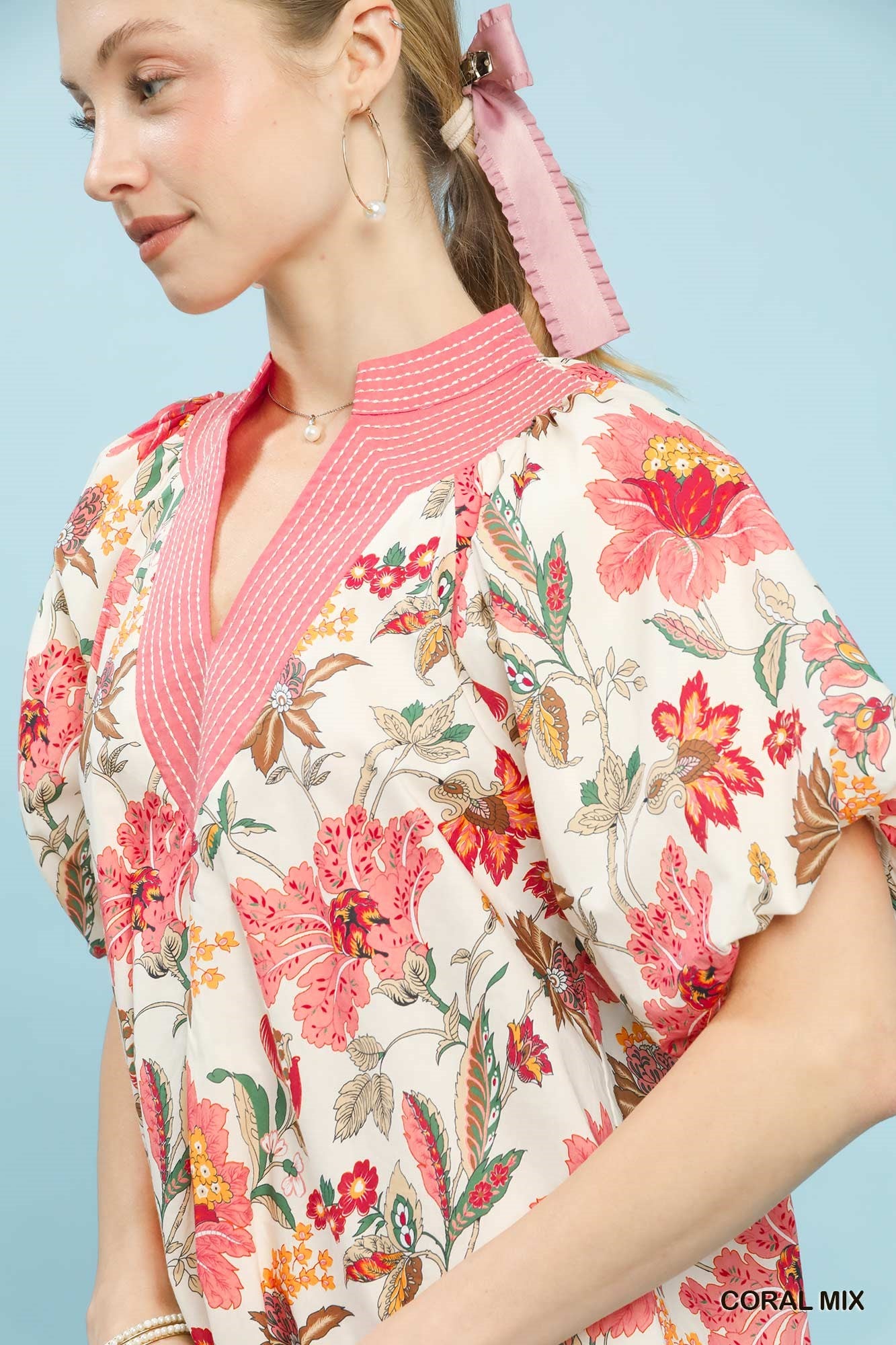 Coral floral puff sleeve blouse by Umgee featuring mixed floral pattern and ruffled sleeves, casual and stylish for everyday wear.