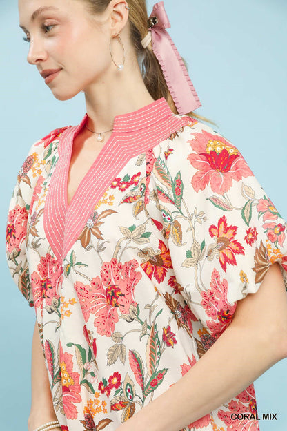 Coral floral puff sleeve blouse by Umgee featuring mixed floral pattern and ruffled sleeves, casual and stylish for everyday wear.
