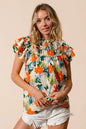 Cream woven top with multi-color floral print from BiBi by Trendsi, featuring a stylish and vibrant design.