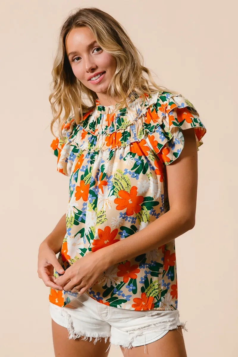 Cream woven top with multicolor floral print from Trendsi, featuring a stylish and vibrant design.