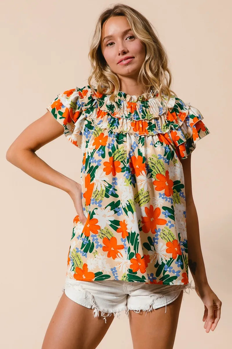 Cream woven top with multicolor floral print from BiBi by Trendsi, featuring a stylish and lightweight design.
