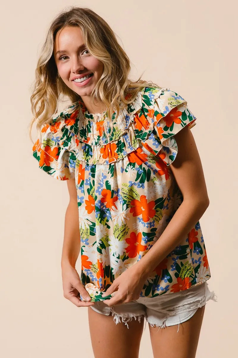 Cream woven top with multicolor floral print from BiBi, showcasing a stylish, lightweight design perfect for casual wear.