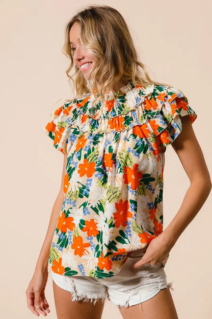 Cream woven top by Trendsi with a vibrant multi-color floral print and long sleeves, stylish and lightweight for casual wear.