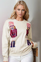 Trendsi Double Take full-size nutcracker sequin long sleeve sweater with festive holiday design and vibrant colors.