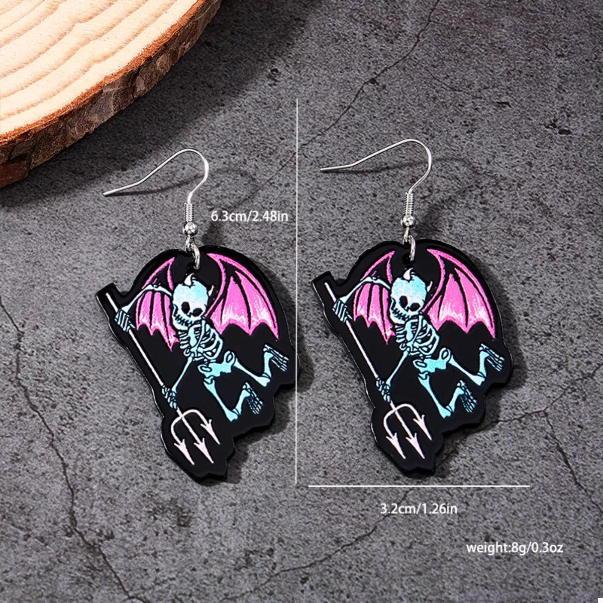 Spooky skeleton devil wing dangle earrings in black with red accents, featuring detailed skeletal and wing designs for Halloween.