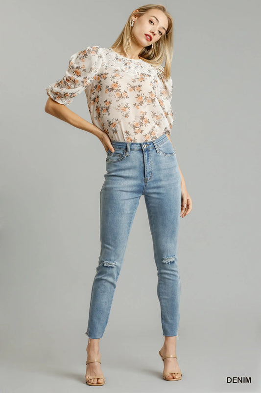 Umgee distressed stretch denim skinny jeans with five pockets and unfinished hem, shown on a model.