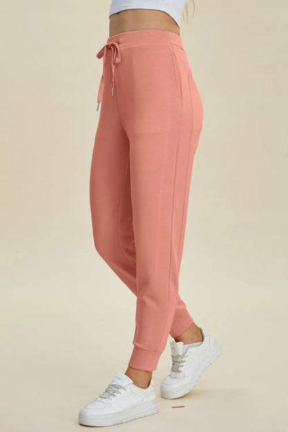 Basic Bae high waist scuba joggers by Trendsi featuring drawstring waist and full length in black fabric.