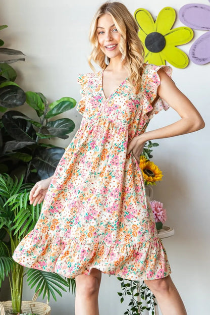 Heimish full size floral ruffled v-neck dress featuring a feminine design with a flowy silhouette and vibrant floral pattern.