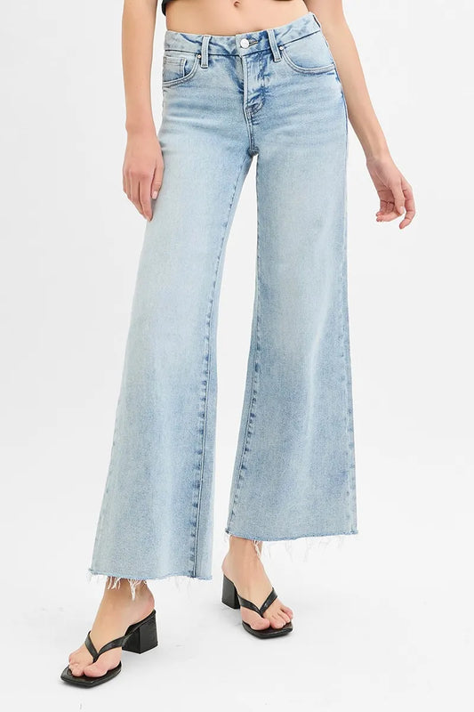 Plus size RISEN low rise wide leg jeans with raw cut hem and tummy control from Trendsi, shown in a full size front view.