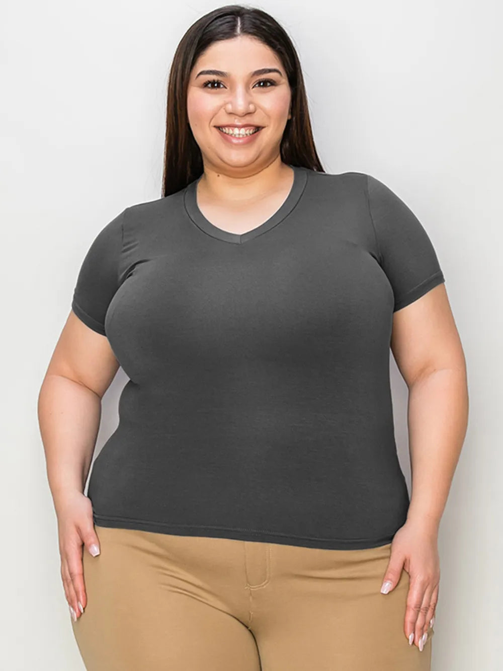 Basic Bae full size V-neck high-low T-shirt by Trendsi, featuring a relaxed fit and soft fabric, shown in a natural pose.