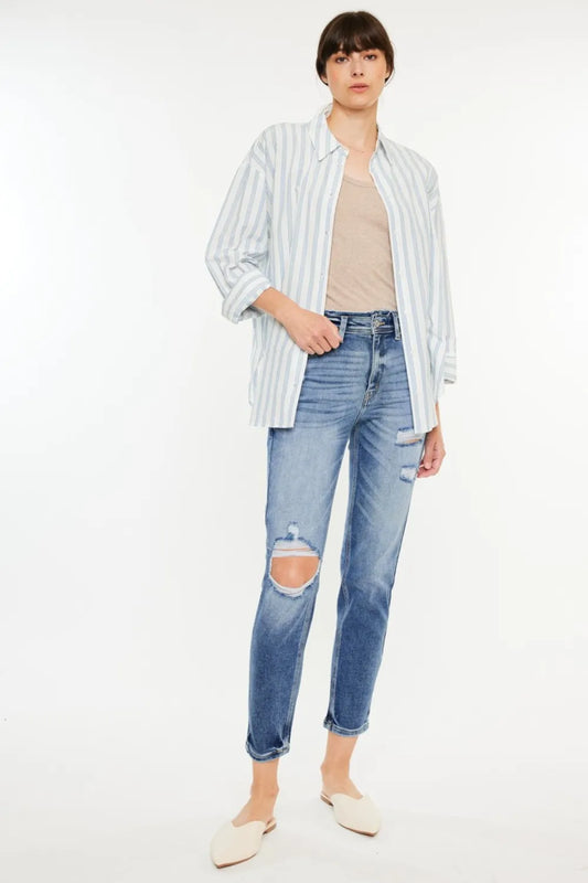Kancan high-rise distressed mom jeans with ripped details and a relaxed fit, shown on a model.