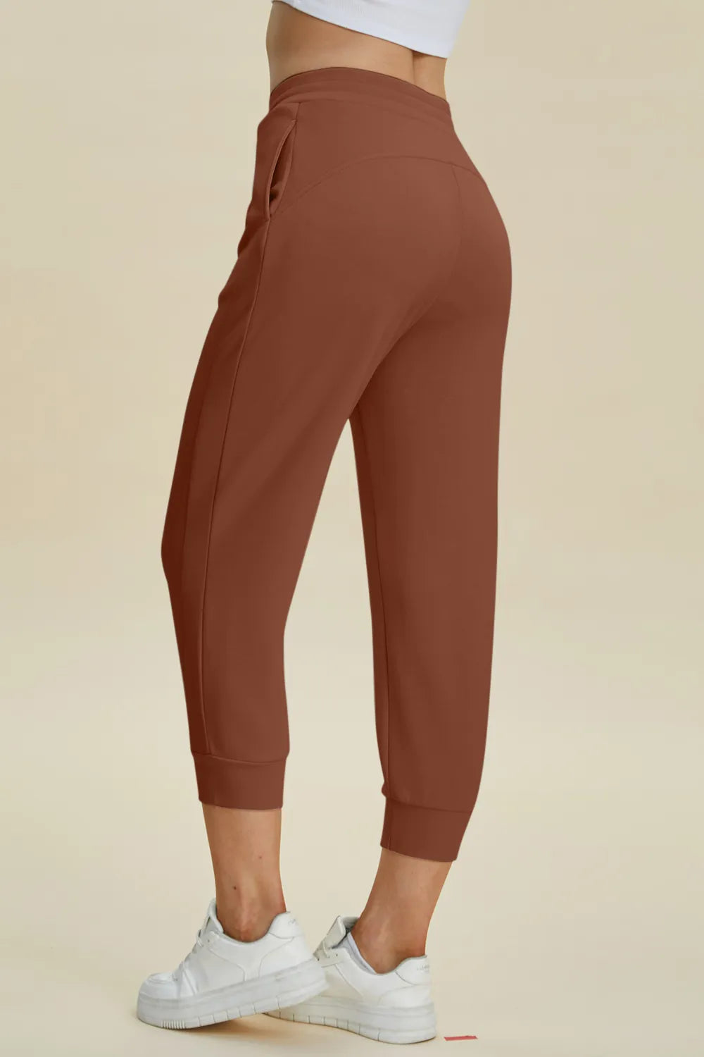 Trendsi Basic Bae full-size air scuba drawstring high waist cropped pants shown in black with relaxed fit and high waist design.