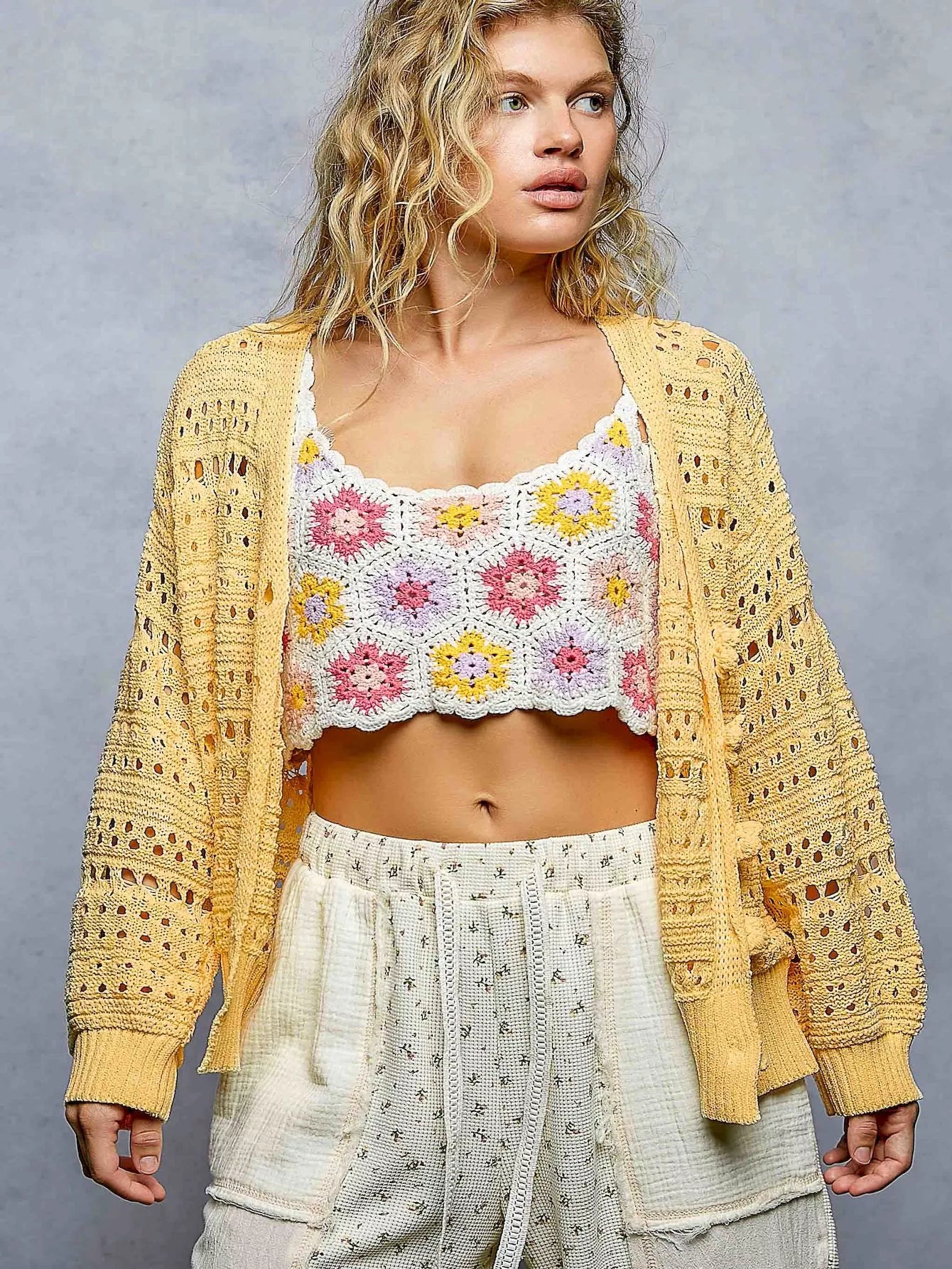 Open-knit floral button cardigan by Trendsi featuring a dandelion pattern, soft fabric, and classic button closure.