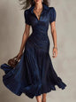 Dark blue pleated striped short sleeve midi dress by Trendsi, showcasing a stylish and flowing design with a round neckline.
