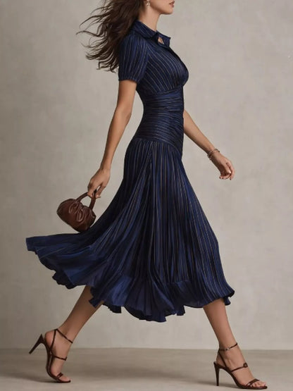 Dark blue pleated striped short sleeve midi dress by Trendsi, showcasing its flowy fabric and stylish pattern.