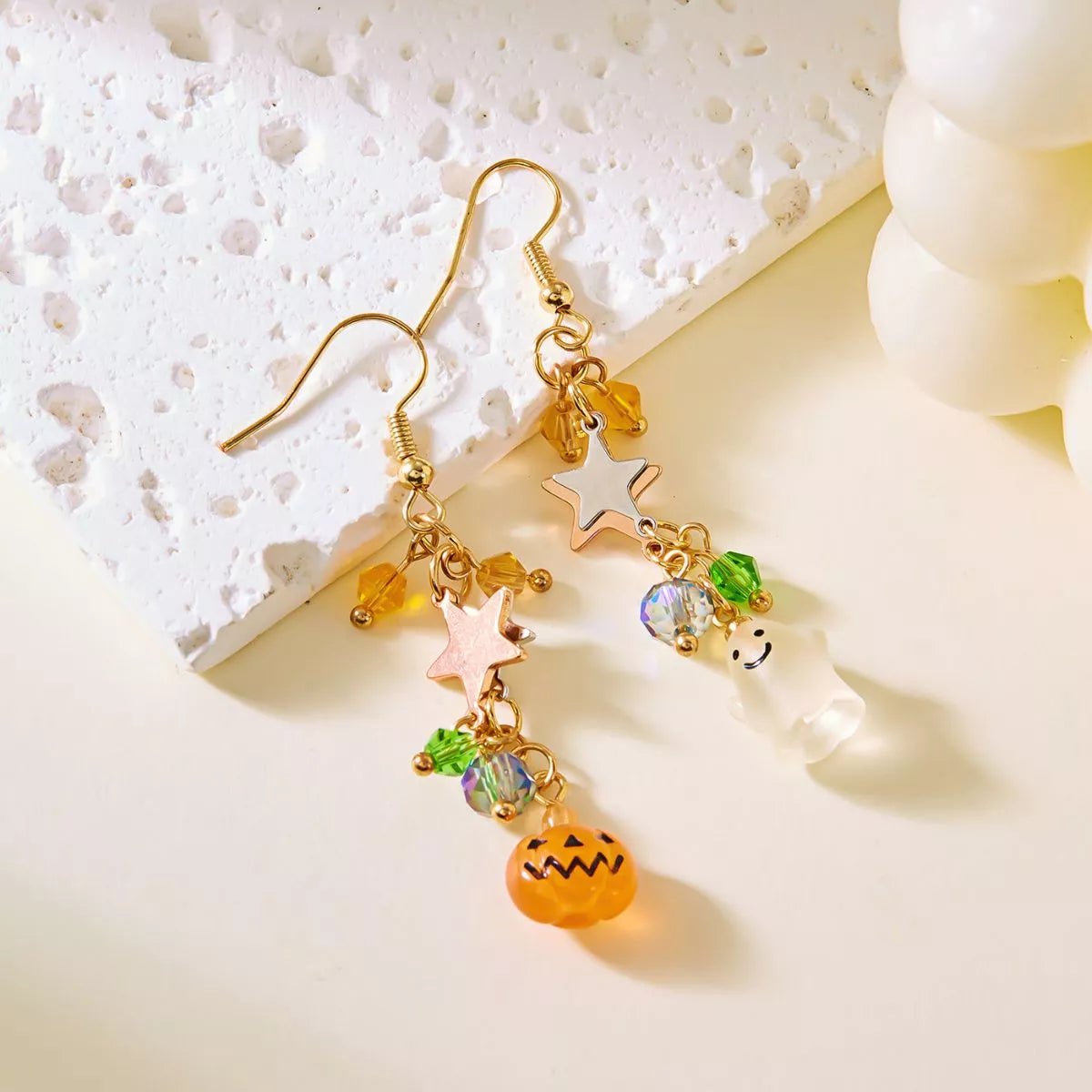 Halloween asymmetrical pumpkin and ghost earrings by Trendsi featuring festive orange pumpkins and spooky ghost charms.