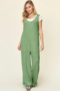Trendsi Double Take full size textured sleeveless wide-leg jumpsuit displayed on a hanger, showcasing its stylish design and fabric details.