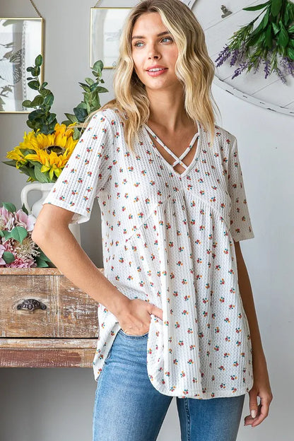 Heimish full size crisscross ditsy floral babydoll top with long sleeves, plus size, featuring a feminine floral pattern and relaxed fit.