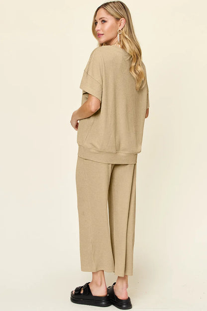 Trendsi Double Take texture round neck short sleeve T-shirt paired with wide-leg pants, showcasing a casual, stylish outfit.
