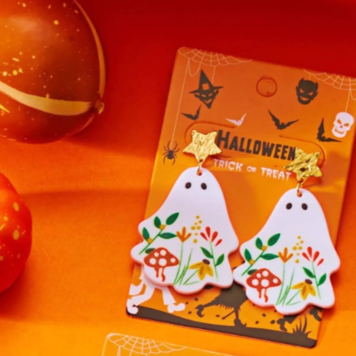 Whimsical ghost earrings with floral design, trendy jewelry featuring playful ghost shapes and delicate floral accents.