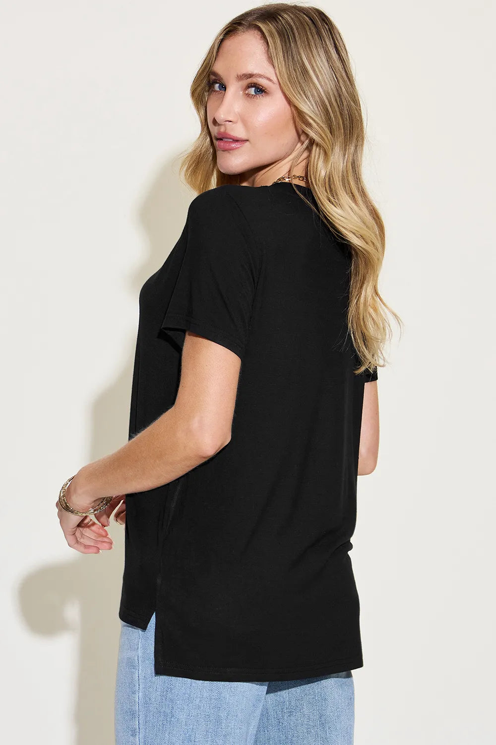 Basic Bae full size V-neck high-low T-shirt by Trendsi, shown in black with a relaxed fit and stylish V-neck design.