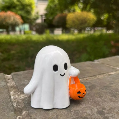 Halloween ghost ornament holding a pumpkin basket, decorative plastic ghost with spooky face for Halloween décor