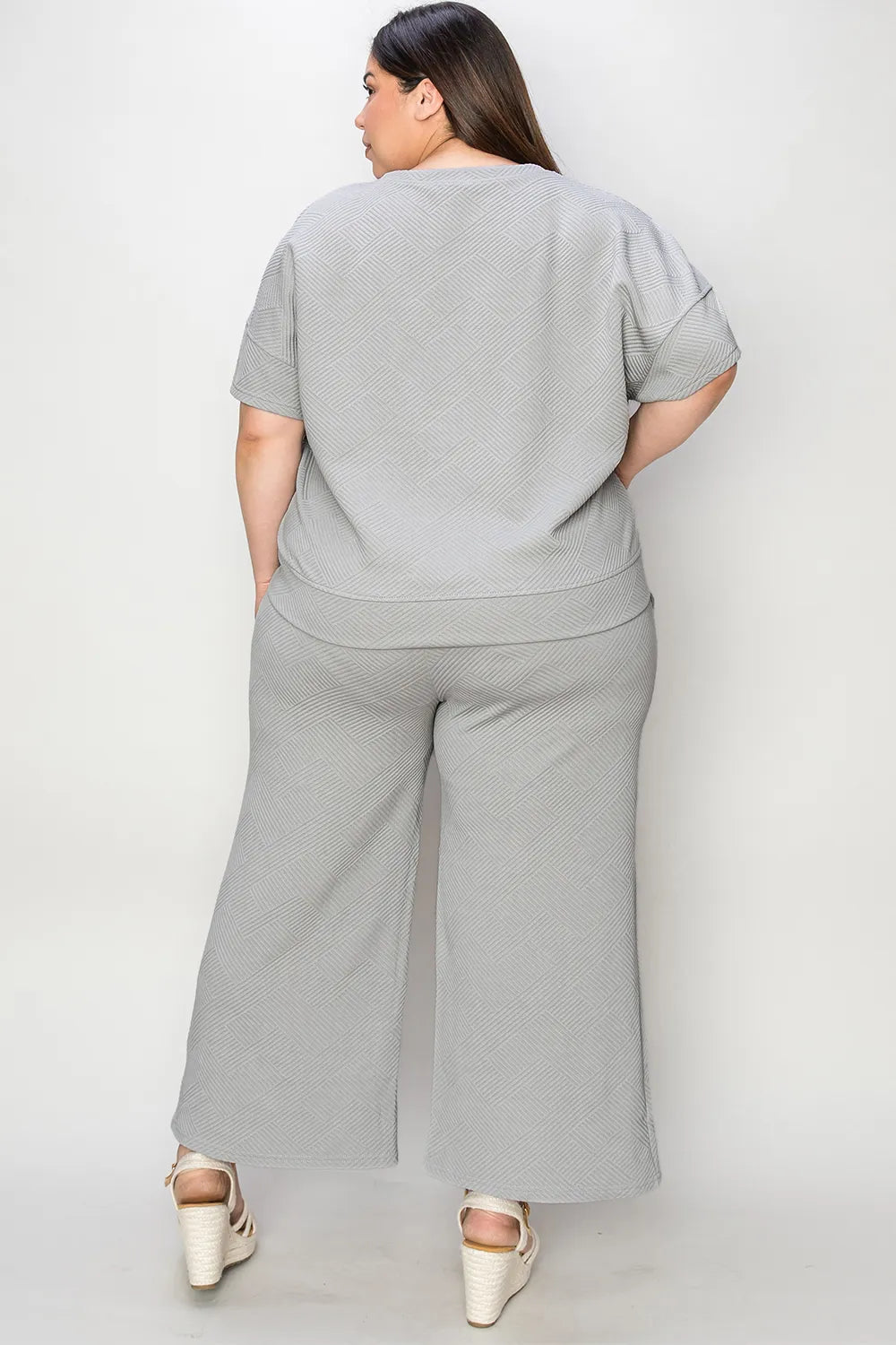Trendsi Double Take full size textured short sleeve top and matching pants set, lightweight fabric, casual fashion ensemble.