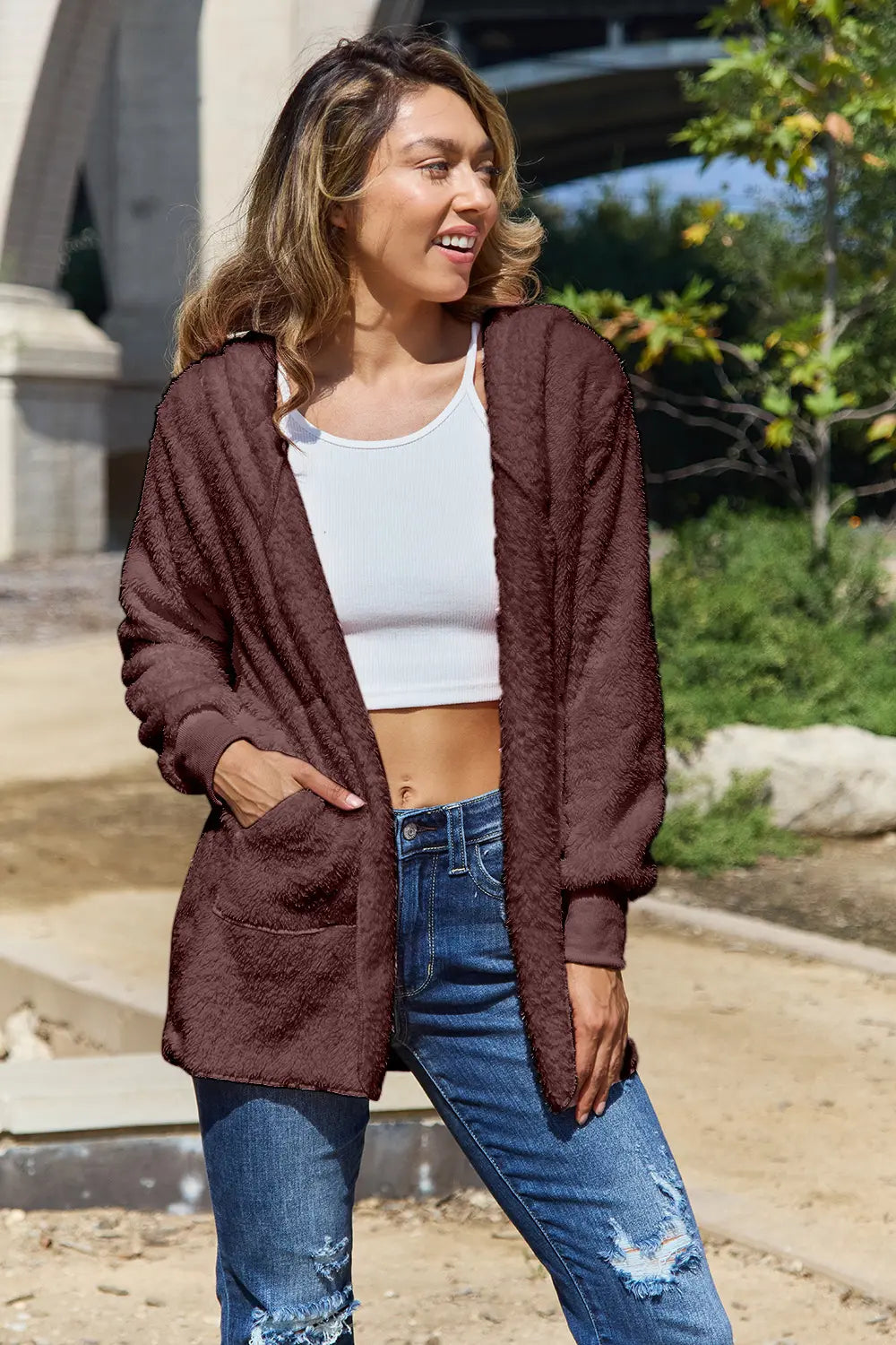 Full size teddy hooded jacket with pockets, soft plush fabric, and cozy style from Trendsi, ideal for casual wear.