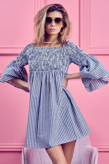 Blue and white striped BiBi Smocked Off Shoulder Dress by Trendsi, featuring a fitted bodice and ruffled off-shoulder neckline.