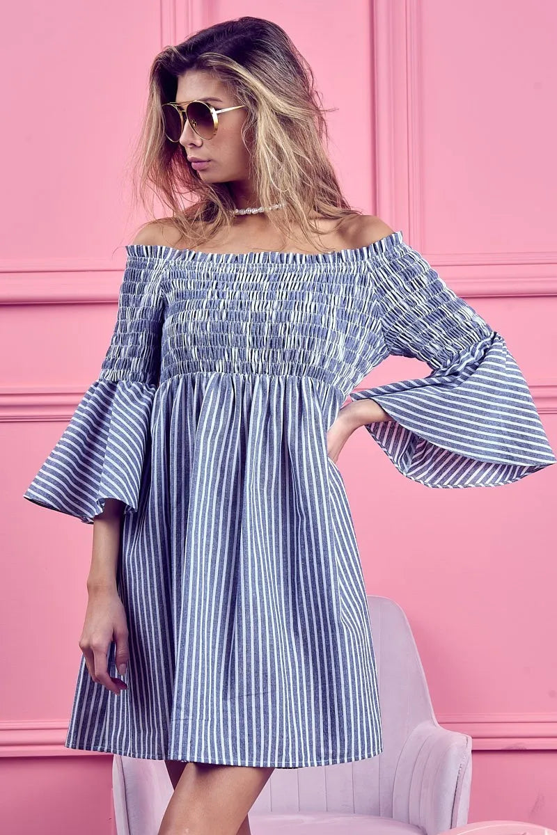 Denim blue BiBi Smocked Off Shoulder Striped Dress by Trendsi featuring a fitted bodice and playful stripe pattern.