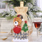 Two festive Christmas doll wine bottle covers in assorted designs, featuring colorful holiday-themed patterns and details.