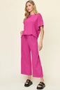 Trendsi Double Take full size textured round neck short sleeve T-shirt and wide-leg pants, casual fashion ensemble.