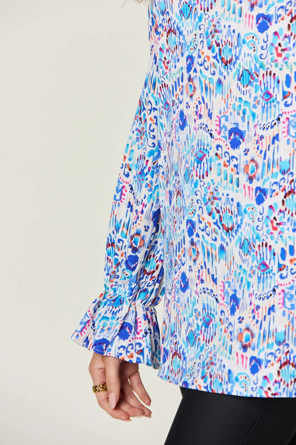 Printed flounce sleeve blouse by Trendsi, featuring double take full size with stylish flared sleeves and vibrant pattern.
