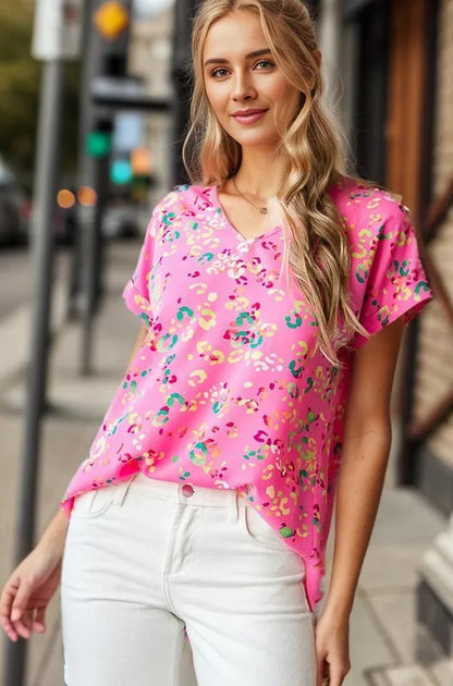 Heimish full size animal print V-neck short sleeve T-shirt in plus size, featuring a bold animal pattern and comfortable fit.
