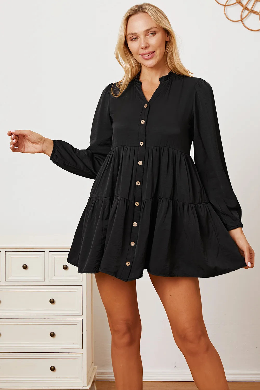 Ruffled button-up long sleeve tiered shirt from Trendsi featuring a feminine design with ruffles and tiered fabric details.