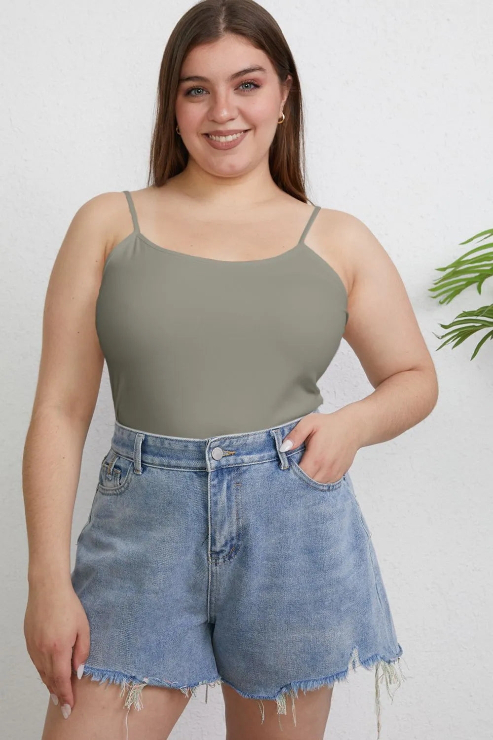 Plus size Basic Bae full-size round neck slim cami by Trendsi, shown in black, featuring a fitted round neckline and sleeveless design.