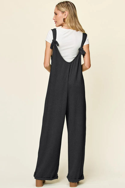 Full view of Trendsi Double Take sleeveless wide-leg jumpsuit with textured fabric and full length, front view on a model.