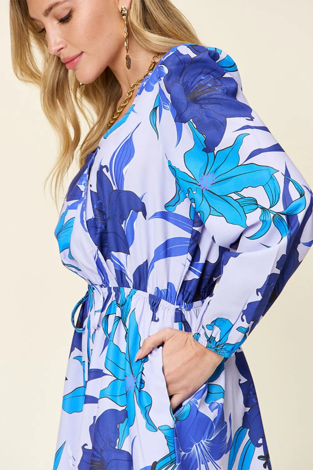 Trendsi Double Take floral long sleeve romper with pockets, full size, featuring a vibrant floral print and comfortable fit.