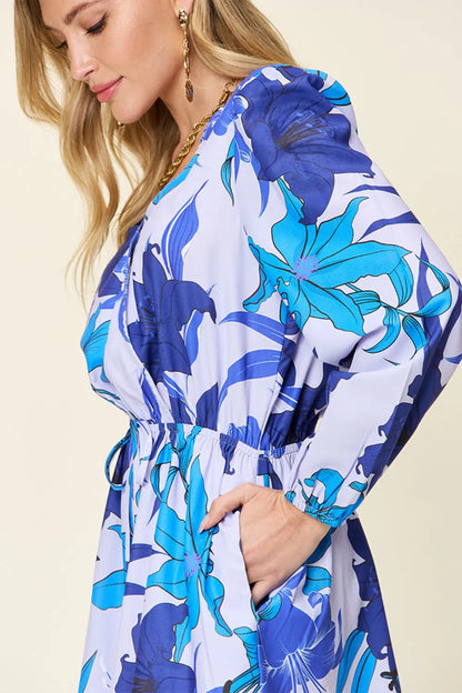 Trendsi Double Take floral long sleeve romper with pockets, full size, featuring a vibrant floral print and comfortable fit.