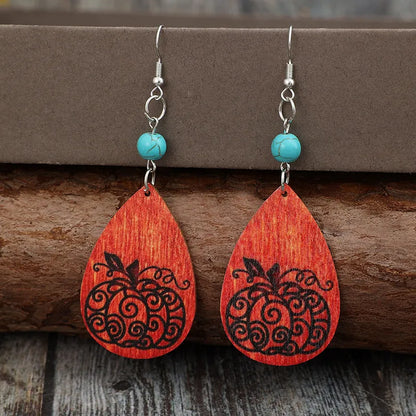 Turquoise wooden pumpkin teardrop earrings featuring handcrafted design and natural wood grain details.